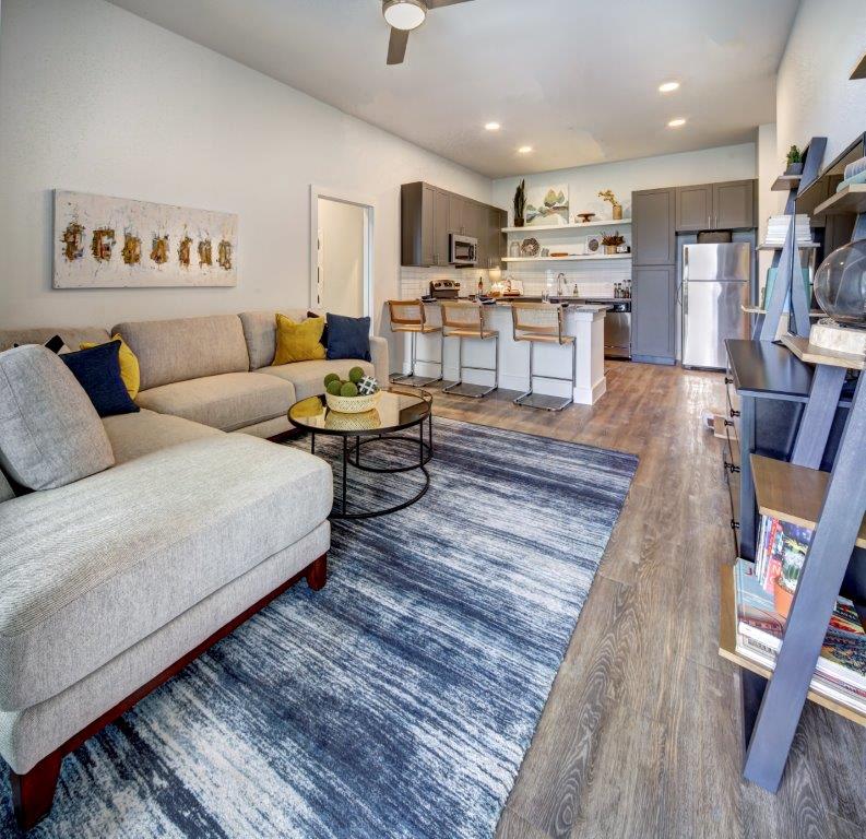 a living room with a couch and a kitchen
